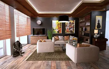 پذیرایی یک خانه با تم قهوه ای که میز در وسط قرار دارد و مبل ها در کنار و تلویزیون در گوشه قرار دارد